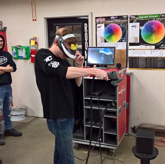 Students in School Activites (Athletics, Classrooms, Plays, Band, Art Projects) (PHS Student at Heartland Career Center Learning to Paint Auto Body with Virtual Reality.jpg)